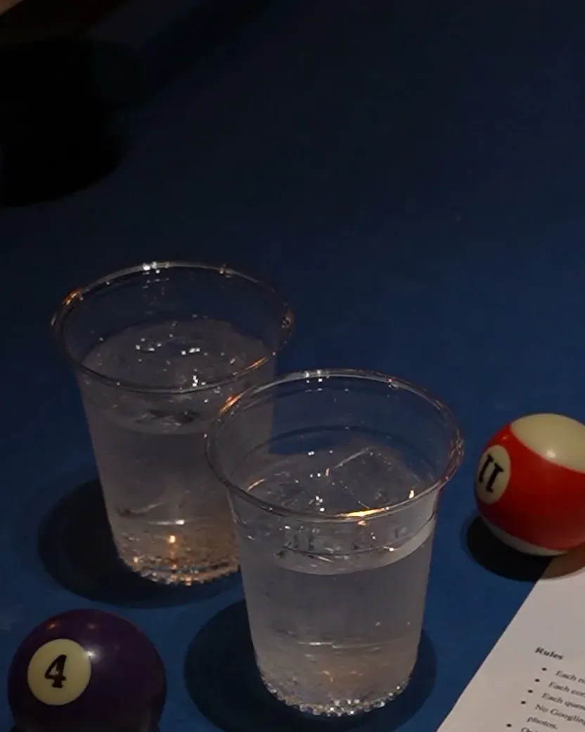 Two glasses and pool balls on the table at Trivia Night